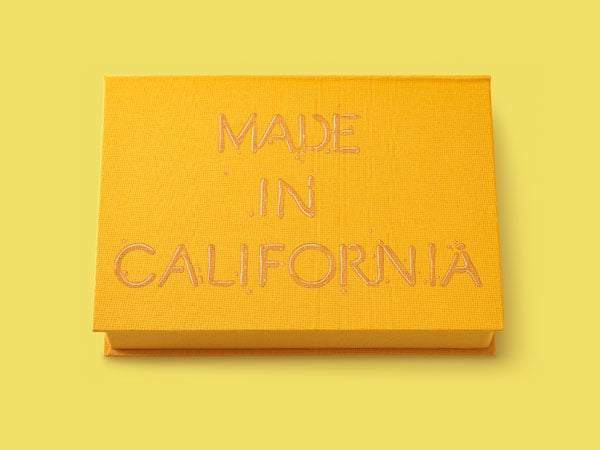 A bright yellow box features the words "Made in California" drawn in a liquid-y style resembling syrup or honey