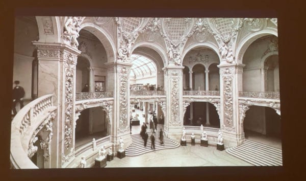 A photograph of an AI animation shows the interiors of the Grand Palais in Paris in the late 19th century.