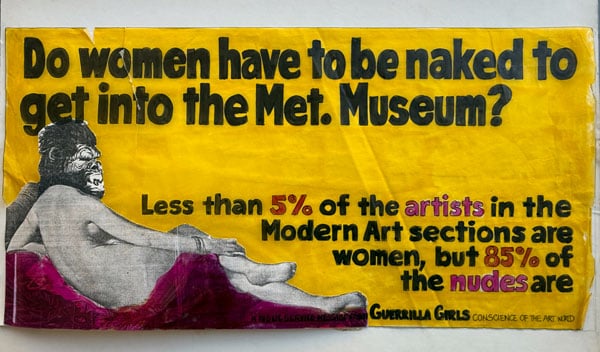 A handrawn graphic features a collage of a painted reclining nude wearing a gorilla mask. A bold text above the figure reads: "Do women have to be naked to get into the Met. Museum?"