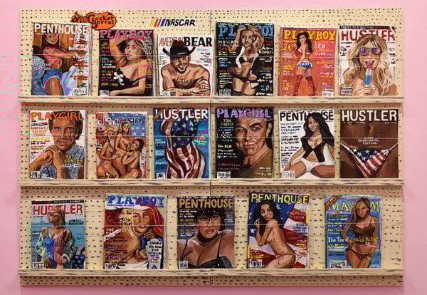 An art installation by Jean Lowe mimics a magazine rack with girlie mags, all crafted out of papier-mache.