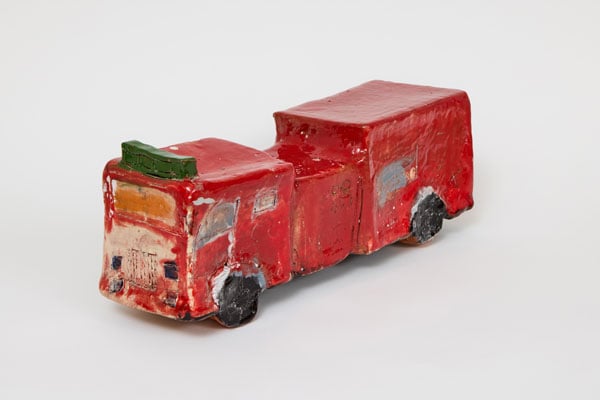 A small ceramic sculpture depicts a fire truck.