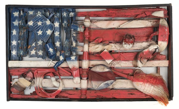 Am assemblage created by Willi Birch shows a rectangular arrangement of objects, including a broom, a show and a dustpan, arranged and painted in a way that portrays the U.S. flag.
