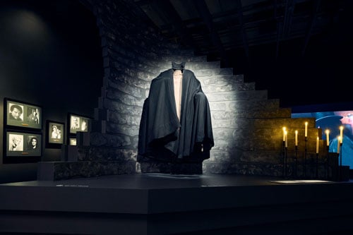 Dracula's cape is shown dramatically illuminated in a museum installation at the Academy.