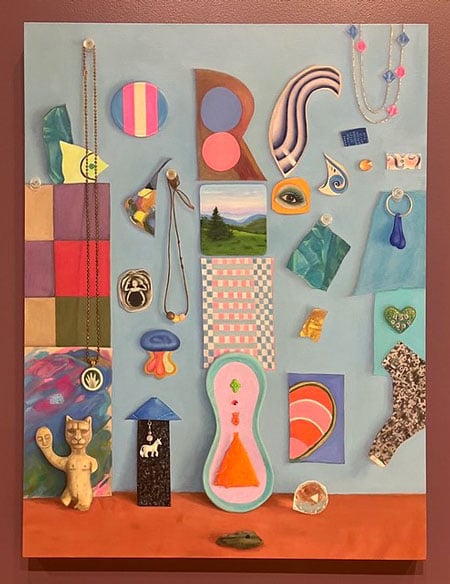 A color painting depicts a shrine-like arrangement of objects against a wall, including a pin bearing the colors of the trans flag, the painting of a small landscape and the image of an eye.