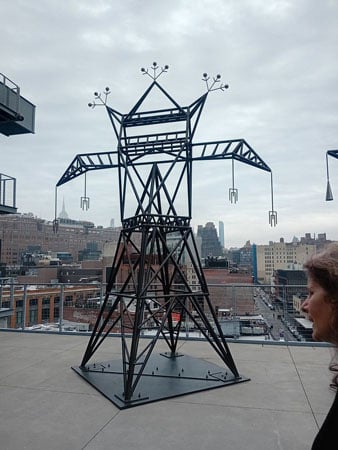 A sculpture on a museum terrace by Nani Chacon resembles an electrical tower that also takes the form of an abstracted Navajo deity