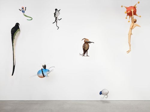 Various otherwordly piñatas inspired the paintings of Hieronymus Bosch are shown before a white wall.