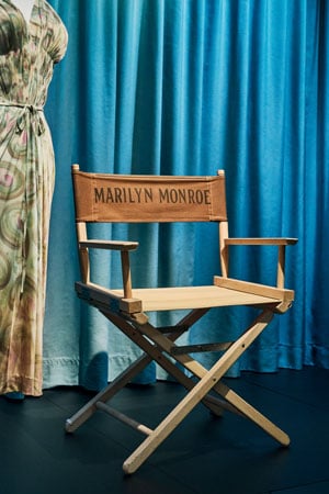 A director's chair emblazoned with Marilyn Monroe's name is displayed in a museum exhibition on the actor's life.