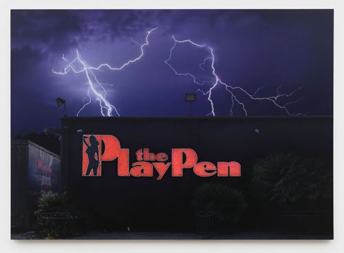 A photorealistic painting shows lightning striking a building that bears a bright neon sign that reads "The PlayPen" and features the silhouette of a woman.