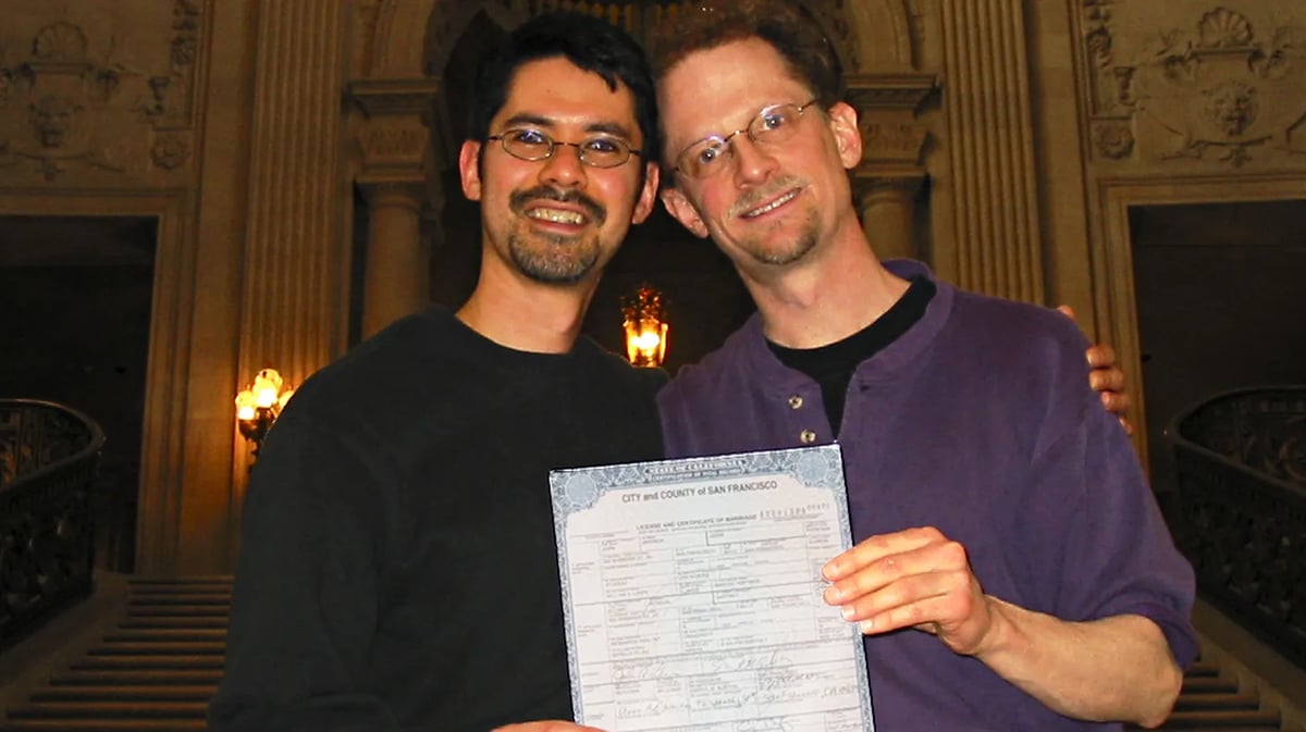Stuart Gaffney (left) and John Lewis (right) hold up their marriage certificate on Feb. 12, 2004. Courtesy of John Lewis and Stuart Gaffney.
