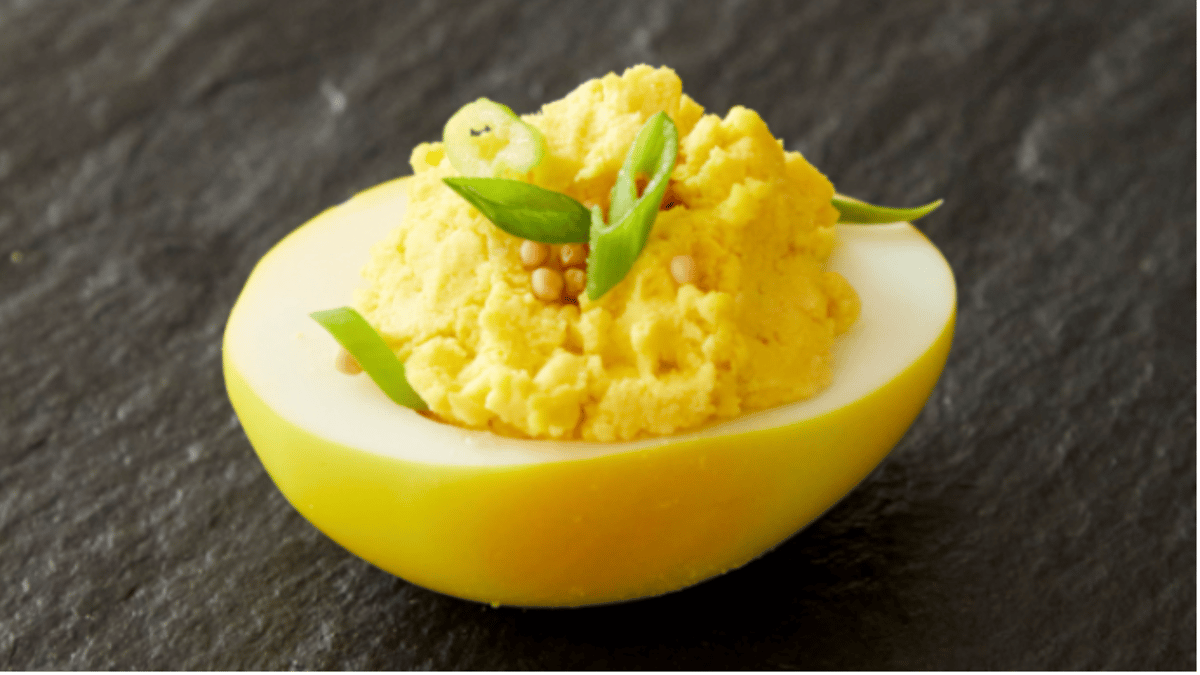 Adding turmeric to turn the egg whites a vibrant yellow, these deviled eggs can take your potluck or Easter spread to the next level. Photo by Tina Rupp.