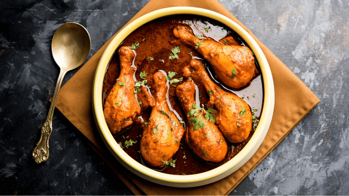 Chicken drumsticks prepared as Murg Tangdi are served in a bowl of fragrant sauce. Photo via Shutterstock.