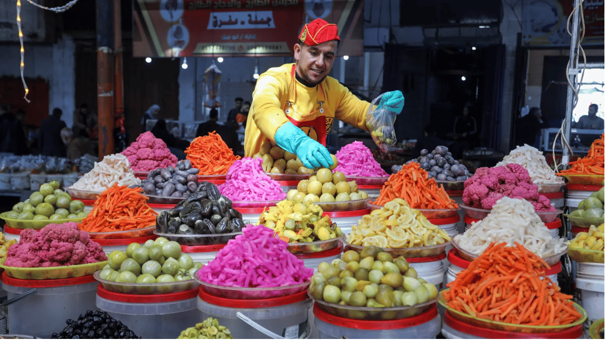 At a market in the city of Rafah, in the southern Gaza Strip, people shop for food ahead of Ramadan. Photo via Shutterstock.