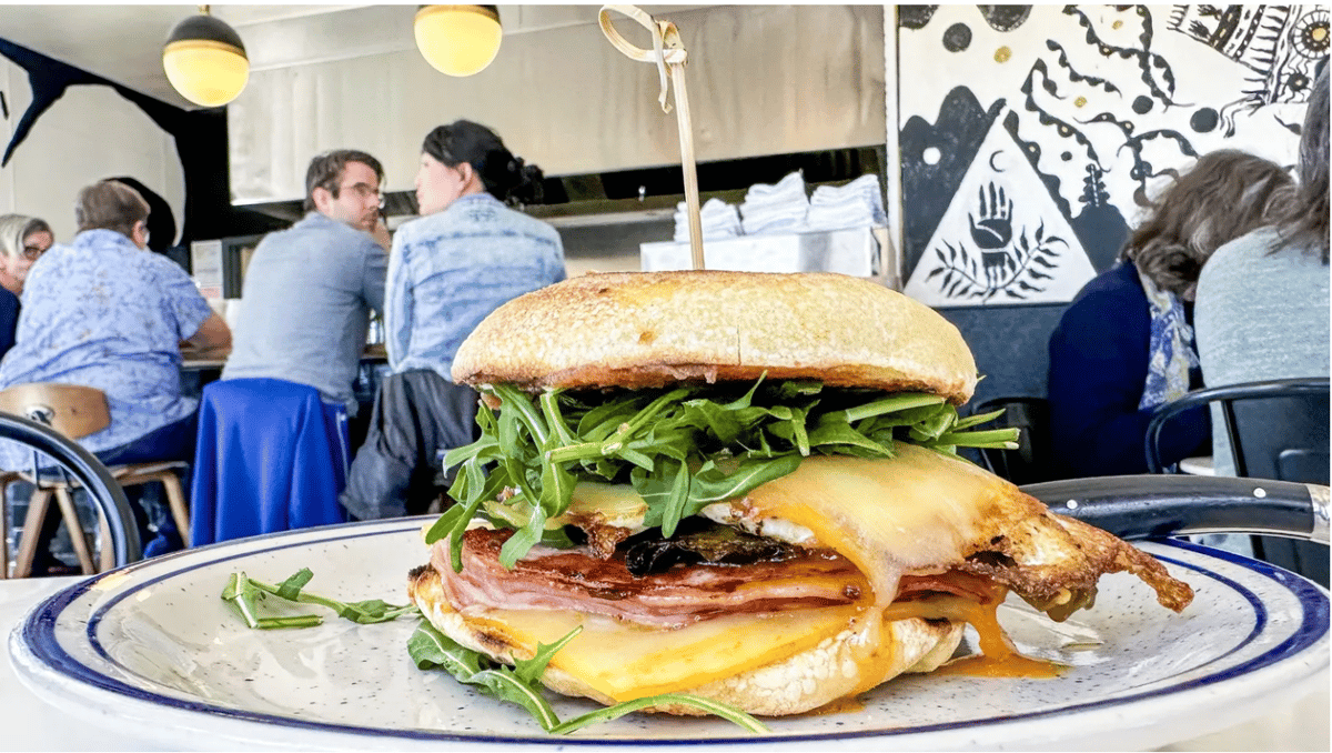 Griddled ham makes friends with a fried egg, muenster cheese, smoked shishito peppers, date jam and arugula in La Copine’s breakfast sandwich. Photo by Bill Addison/Los Angeles Times.