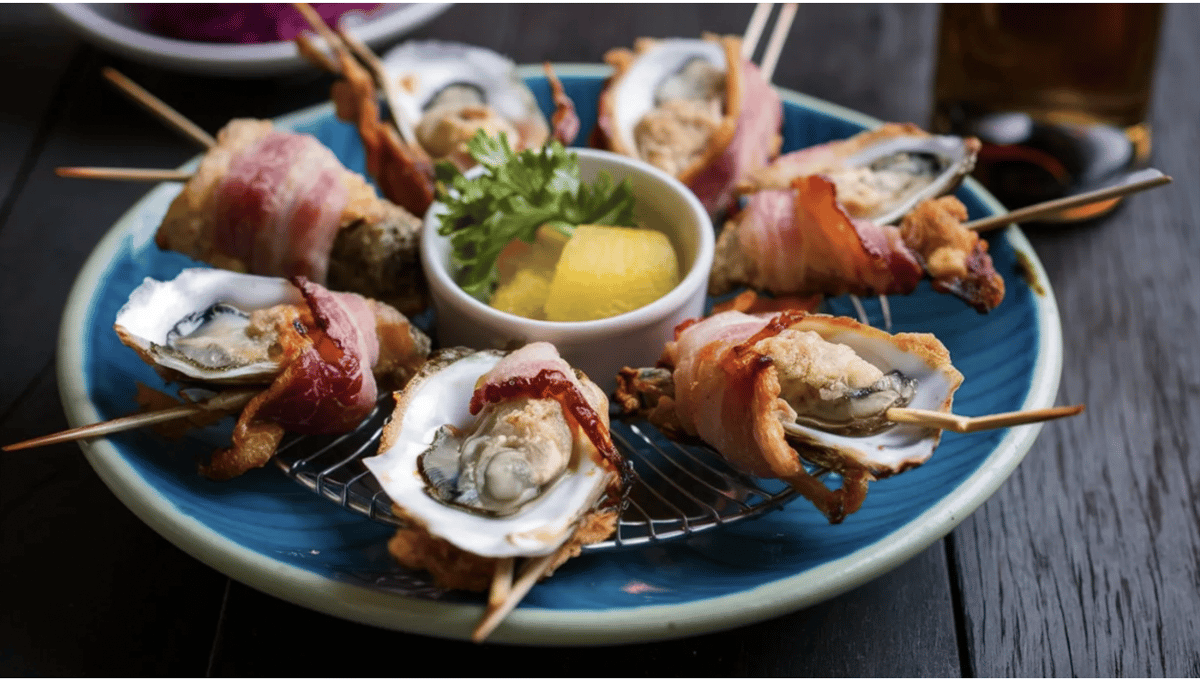 Oysters en brochette aka bacon-wrapped oysters is one way to prepare shellfish. Photo via Shutterstock