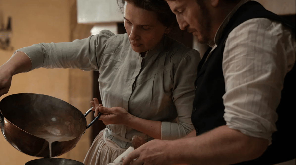 Eugénie (Juliette Binoche) and Dodin (Benoît Magimel) cook together in Tran Anh Hung's "The Taste of Things." Courtesy of Stéphanie Branchu. An IFC Films Release.