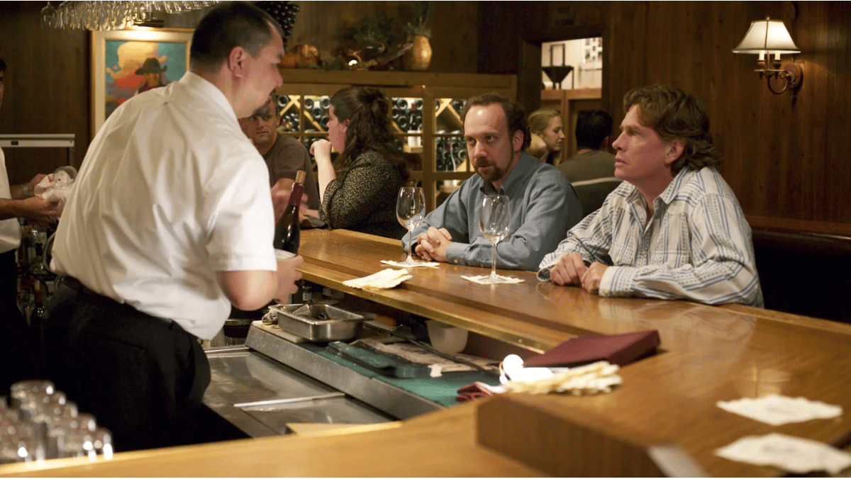 Paul Giamatti (center) and Thomas Hayden Church (right) sit at the Hitching Post bar in a scene from "Sideways." Photo courtesy of Searchlight Pictures.