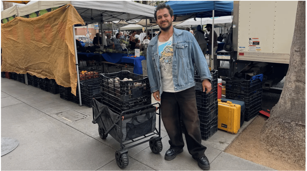 Balo Orozco hauls away 150 pounds of passionfruit from the Santa Monica Farmers' Market. Photo by Gillian Ferguson/KCRW