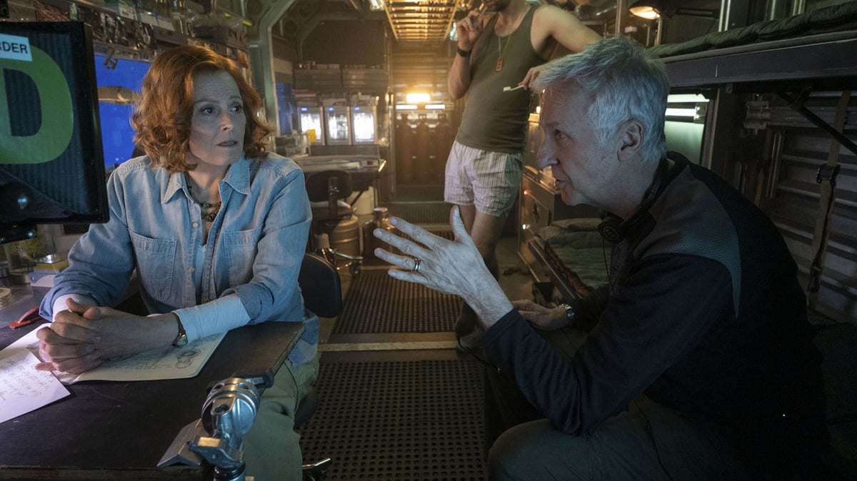 Director James Cameron (R) talks with actors Sigourney Weaver (L) and Joel David Moore on the set of Avatar: The Way of Water. Photo courtesy of Mark Fellman. © 2022 20th Century Studios.