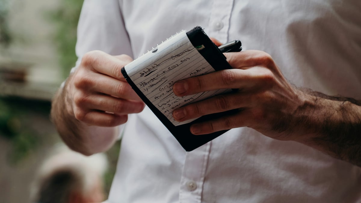 waiter holds notepad